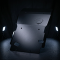 Dark metal object with circular components on a black background